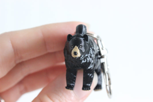 Black bear keychain held in a person's hand 